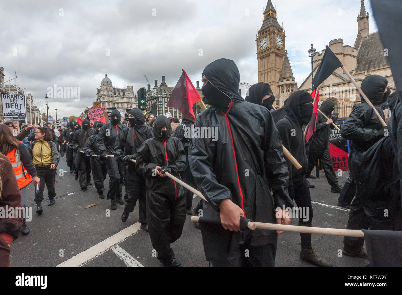 The Black bloc on the NCAFC Student march for free education - No Barriers, No Borders, No Business in Parliament Square. Stock Photo
