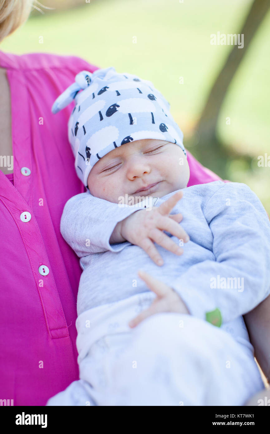young mother with newborn baby outdoors Stock Photo
