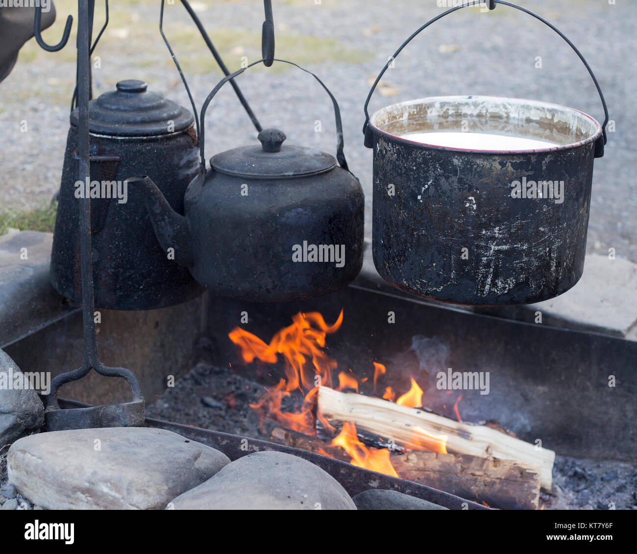 Water heating in pot over campfire at roundup camp to make cowboy coffee recreating late 1800s experience for visitors on Bar U Ranch, Alberta, Canada Stock Photo