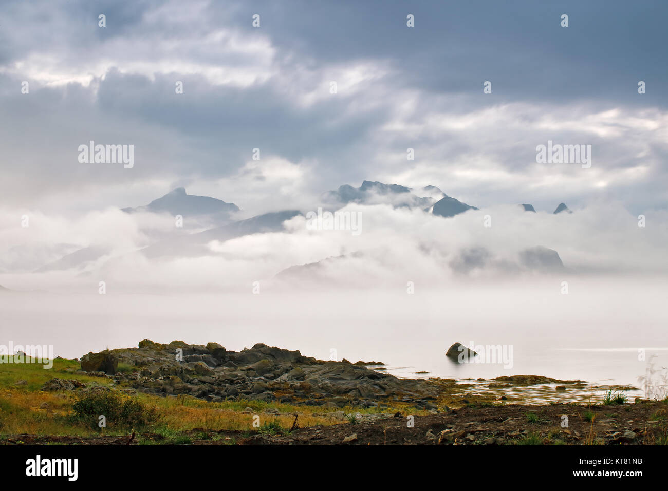 Coast of  Norway sea in clouds of fog. Cloudy Nordic day. Stock Photo