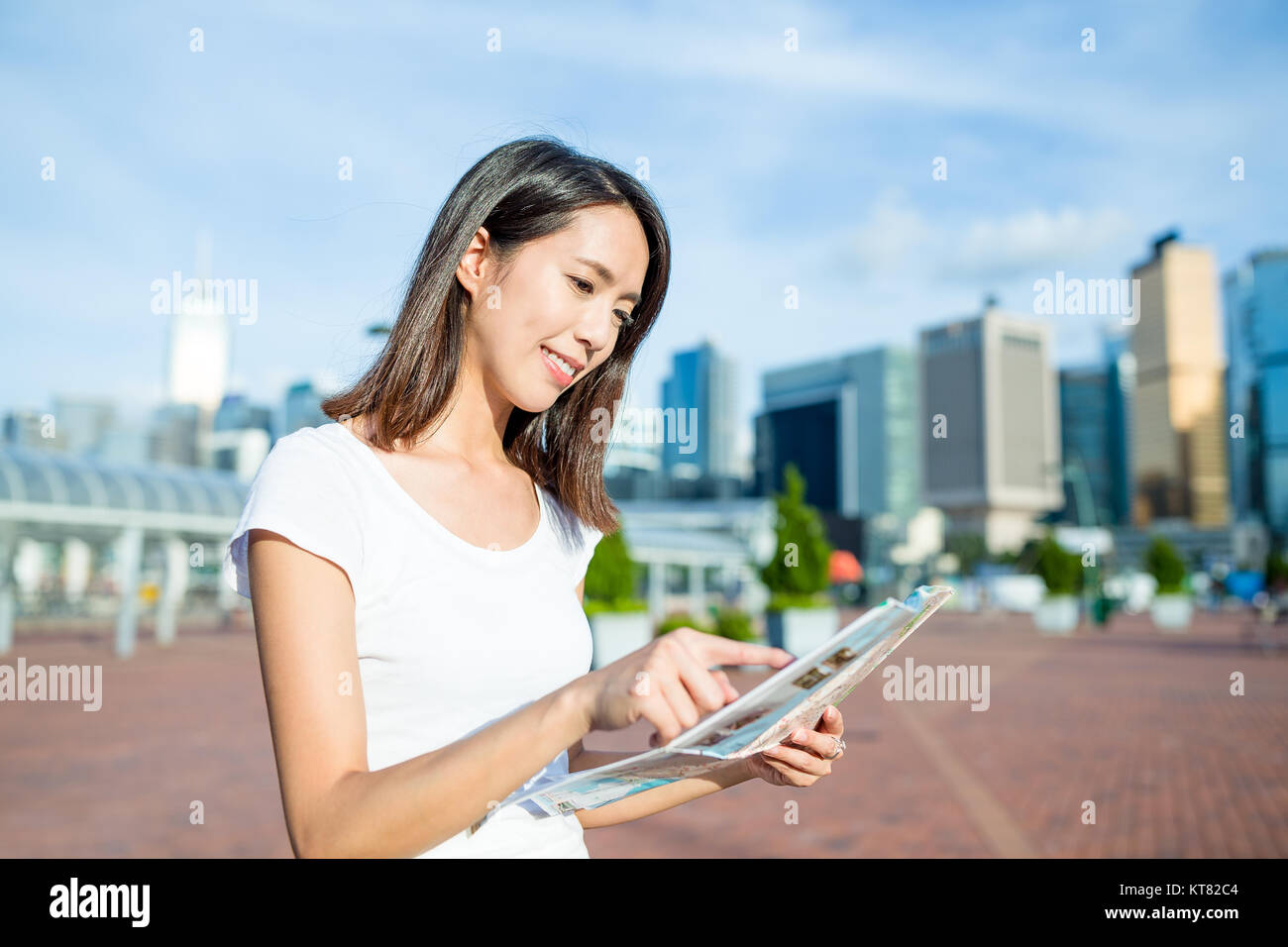 Woman looking on city map in Hong Kong Stock Photo - Alamy