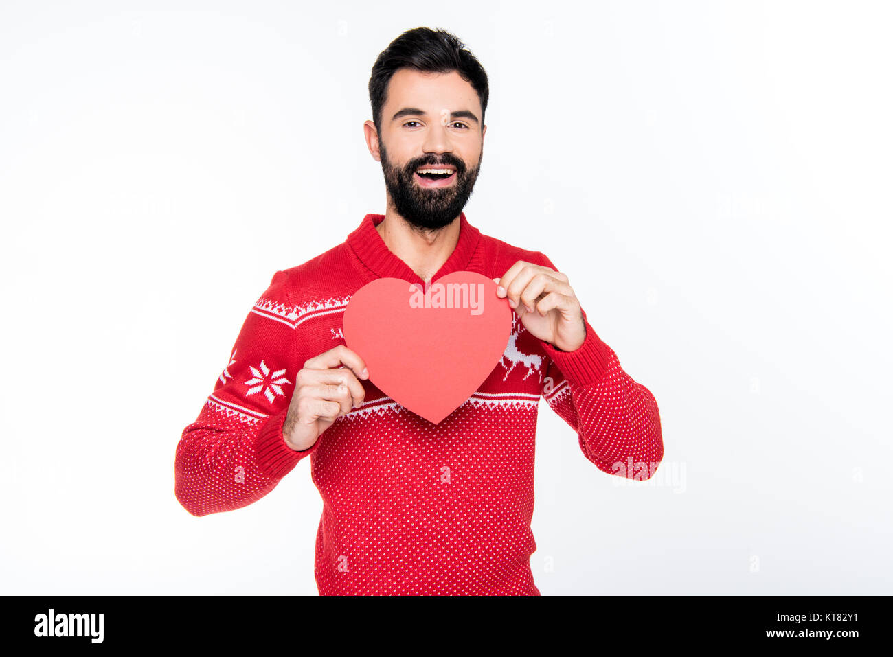 Smiling man holding red heart Stock Photo - Alamy