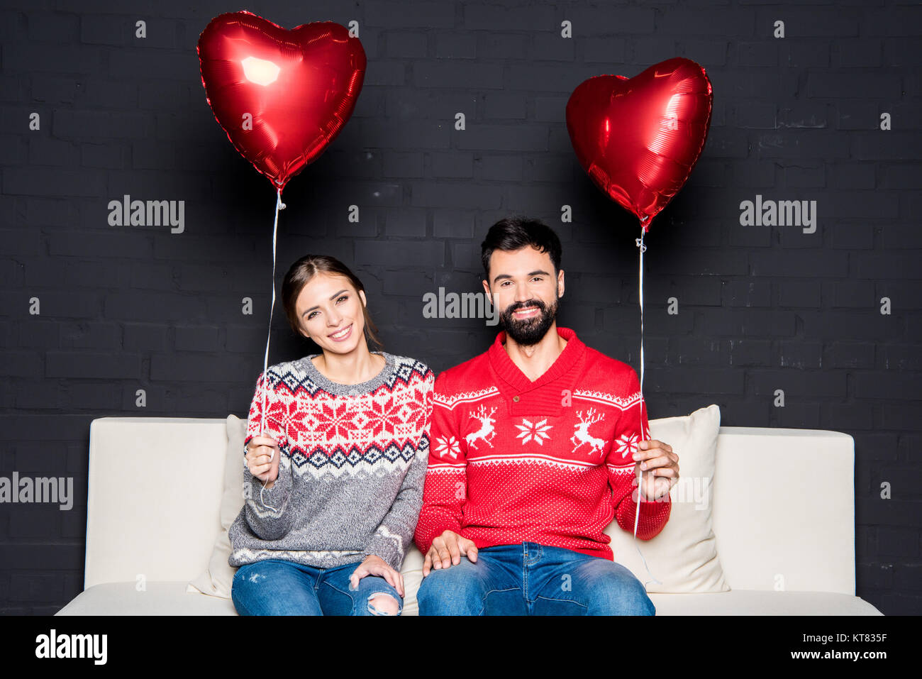 Couple with red hearts balloons Stock Photo - Alamy