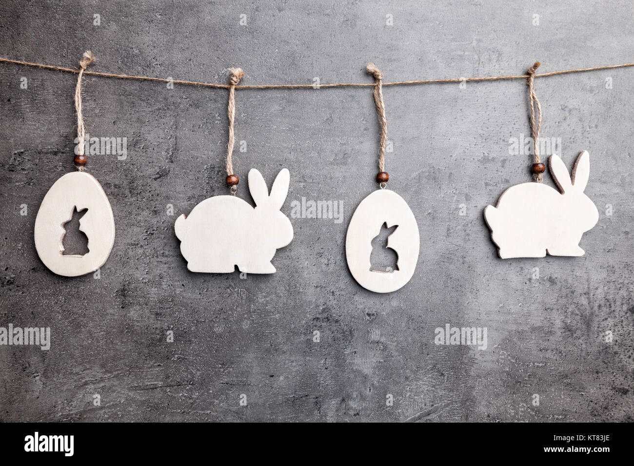 Easter decoration bunnies hanging on a string Stock Photo - Alamy