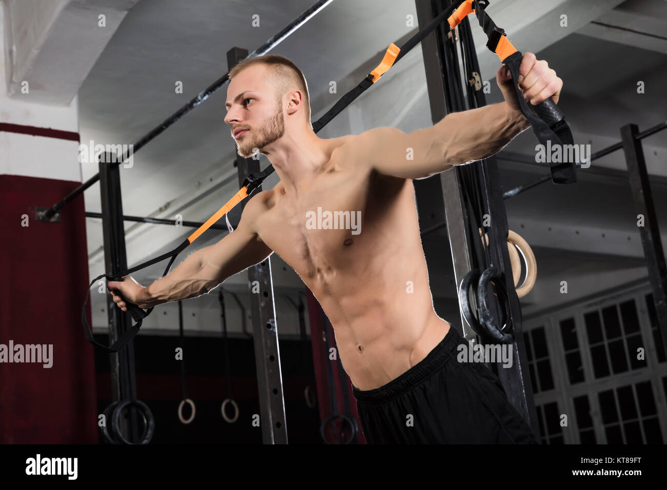 Man Exercising With Suspension Trainer Stock Photo Alamy