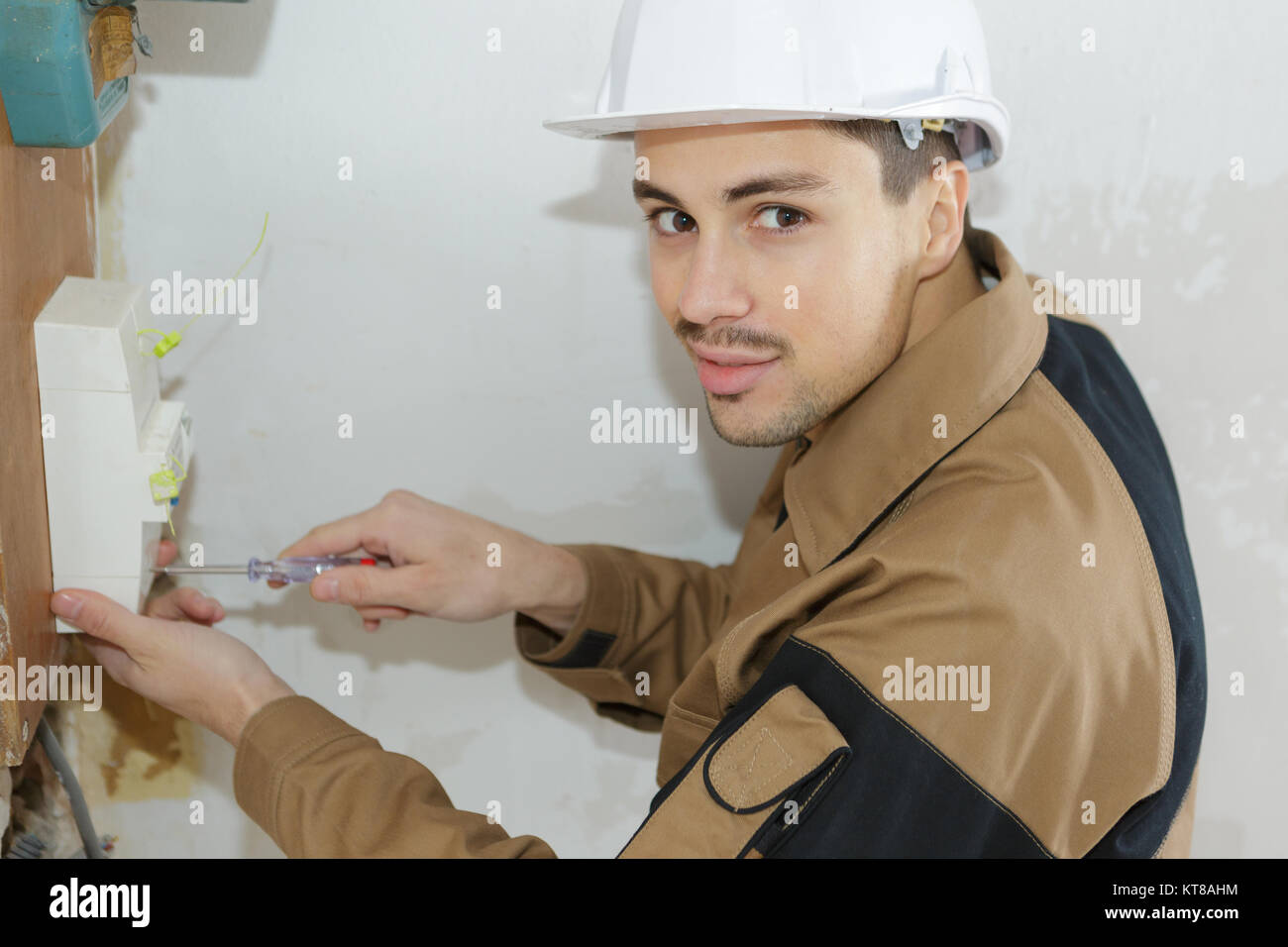 young electrician repairs electric motor engineering profession Stock