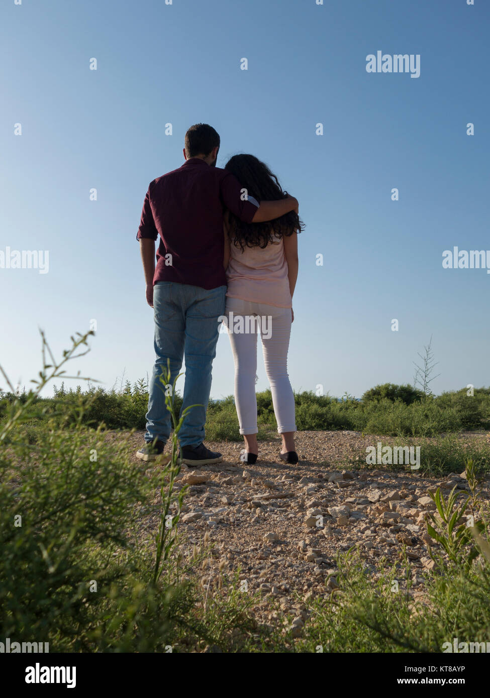 Rear view of a young couple standing outdoors Stock Photo - Alamy