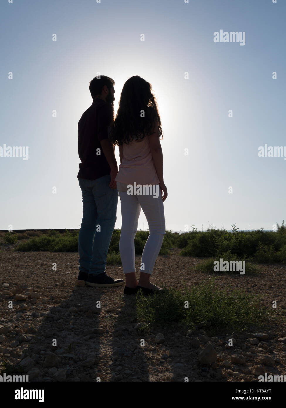 Rear view of a young couple standing outdoors Stock Photo - Alamy