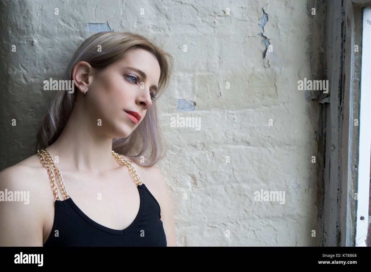 Sad woman looking out of the window Stock Photo - Alamy