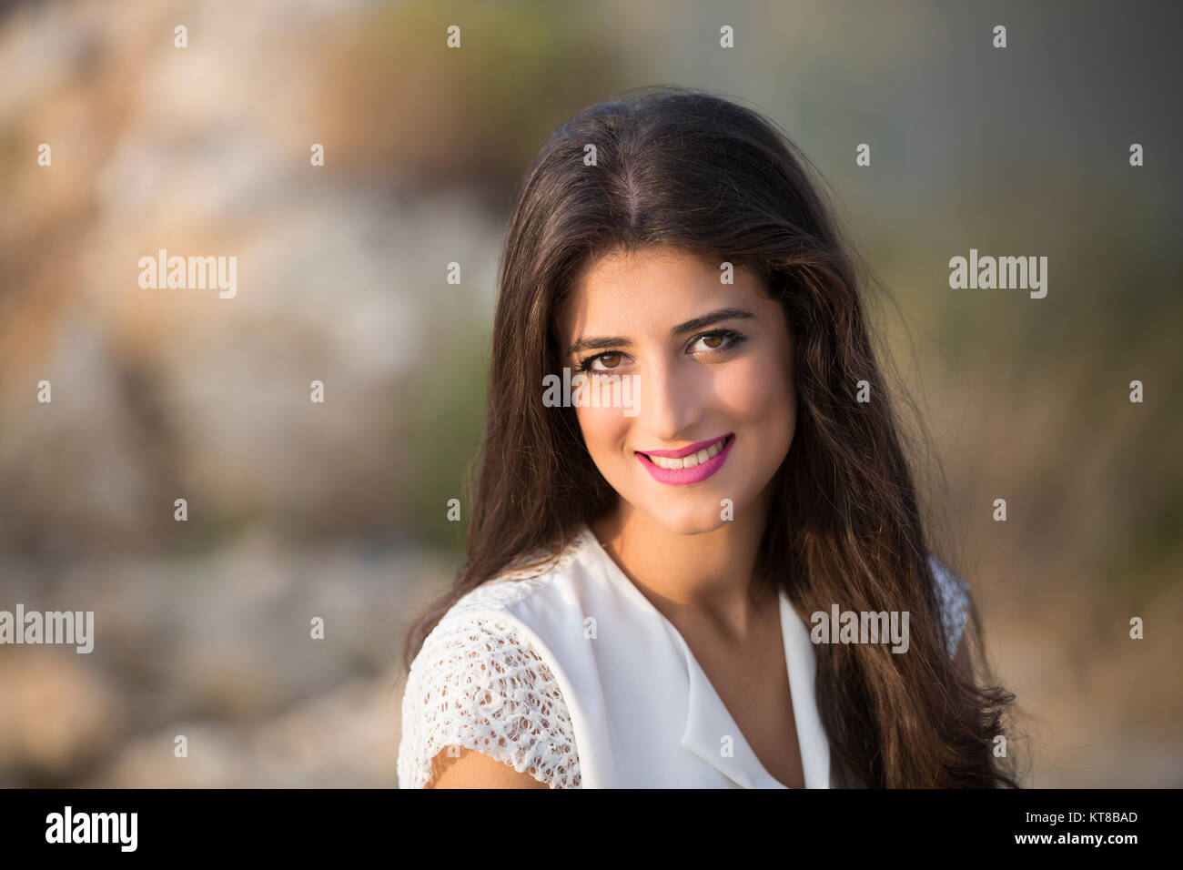 Portrait of a beautiful young woman smiling outdoors Stock Photo - Alamy