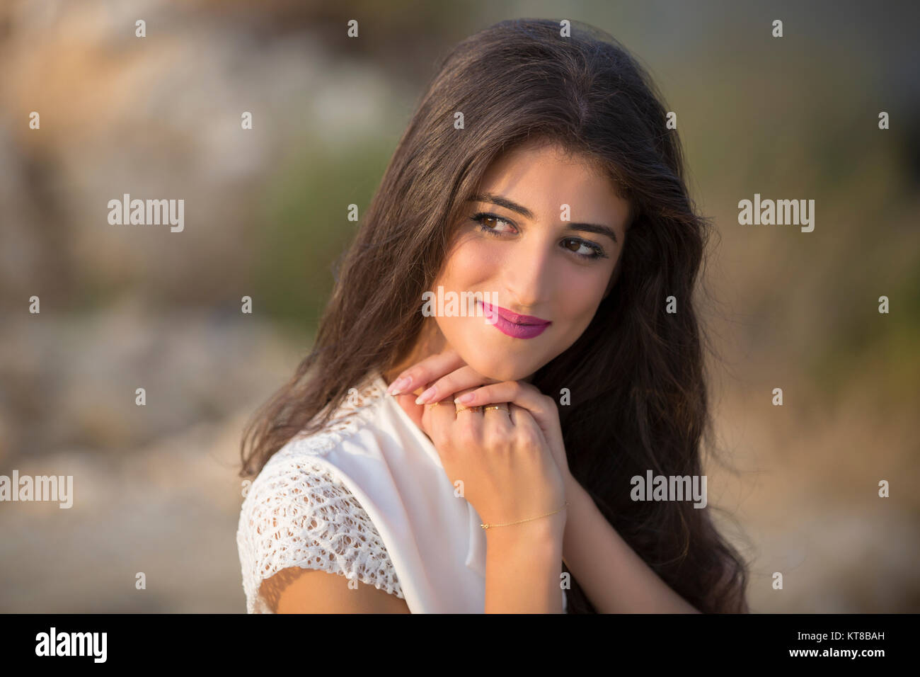 Portrait of a beautiful young woman smiling outdoors Stock Photo - Alamy