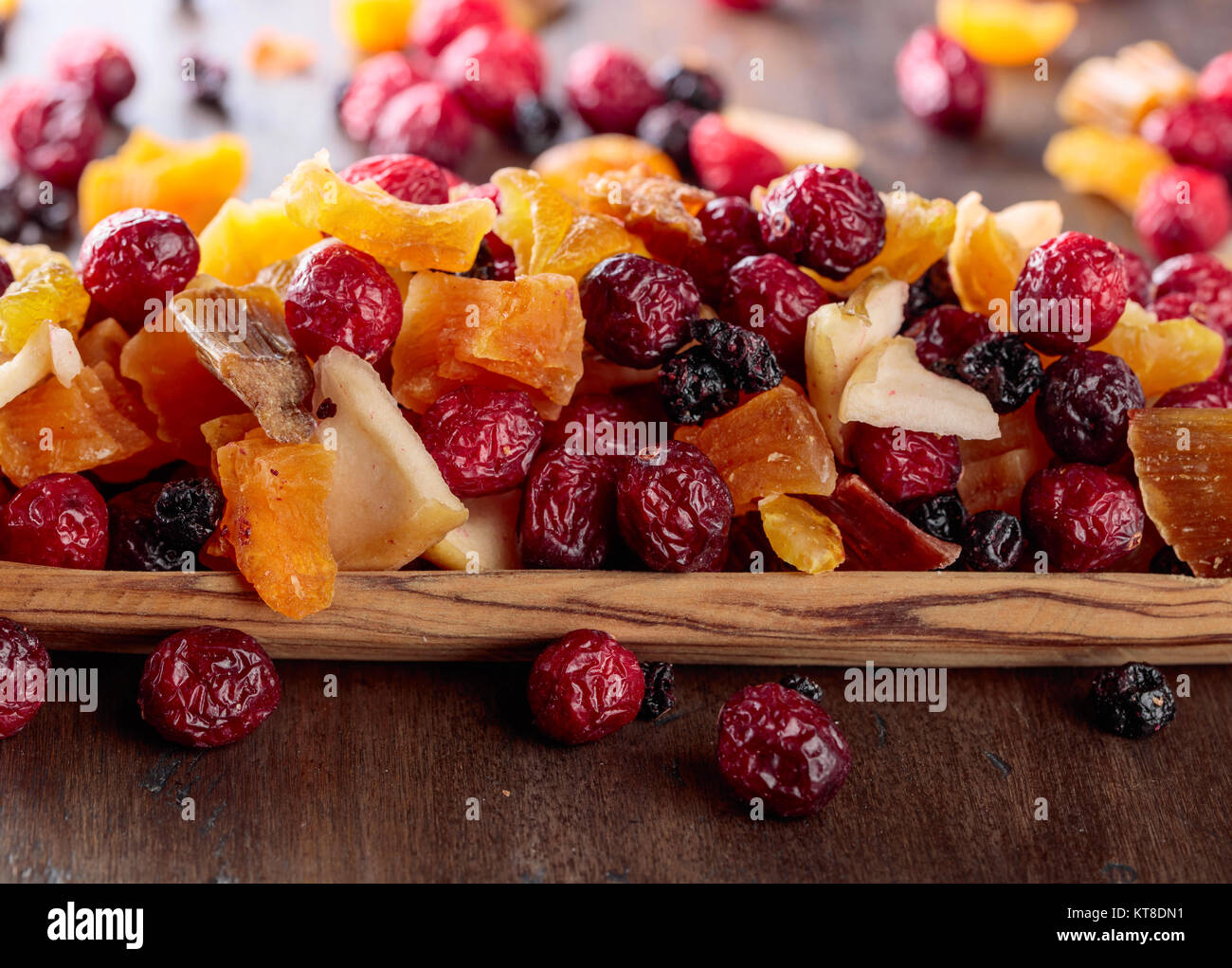 Mix of dried fruits and berries on a wooden table Stock Photo - Alamy