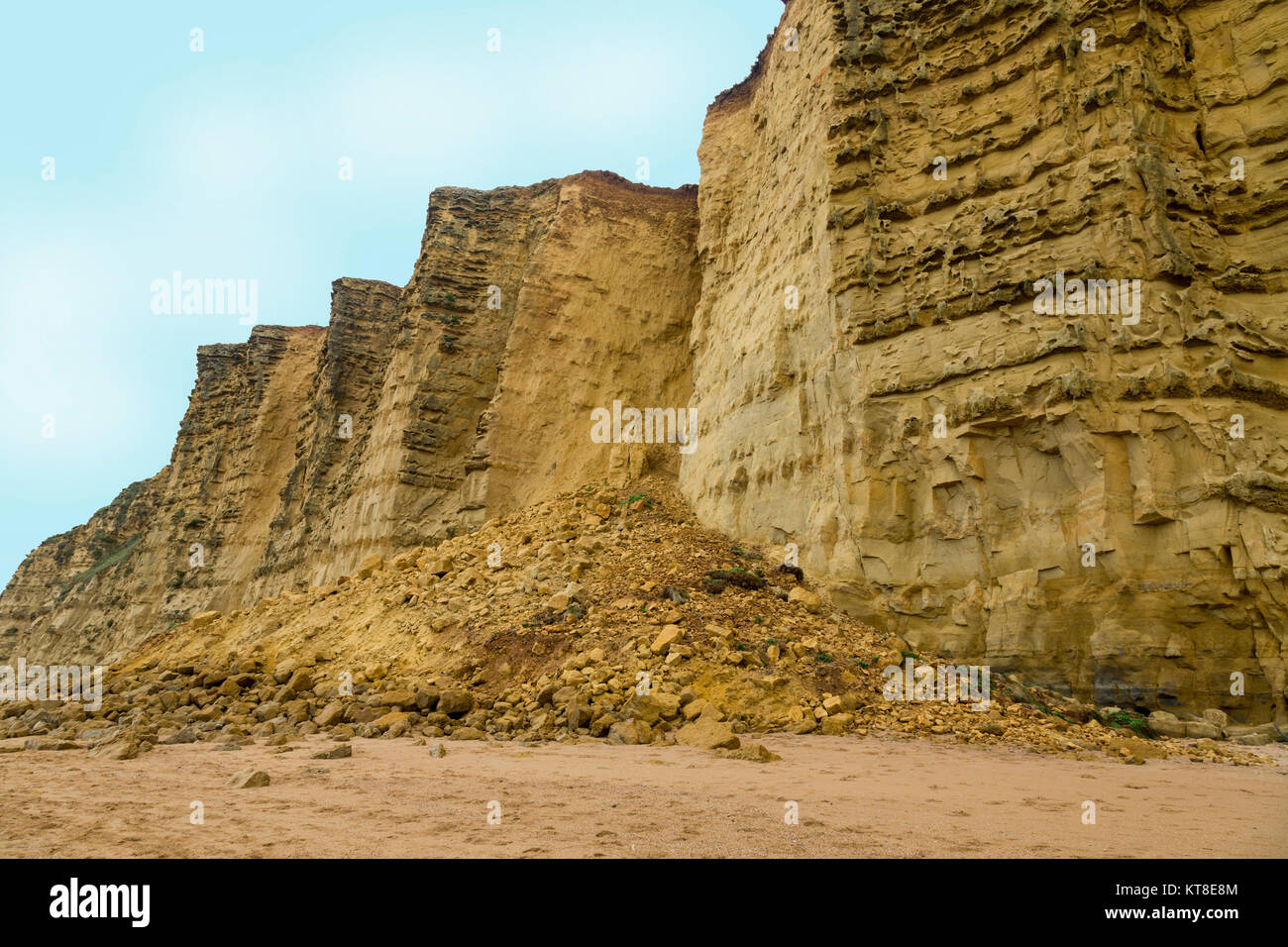 A huge cliff fall of sandstone from East Cliff spills on to the beach after a winter storm on the Jurassic Coast near West Bay, Dorset, England, UK Stock Photo