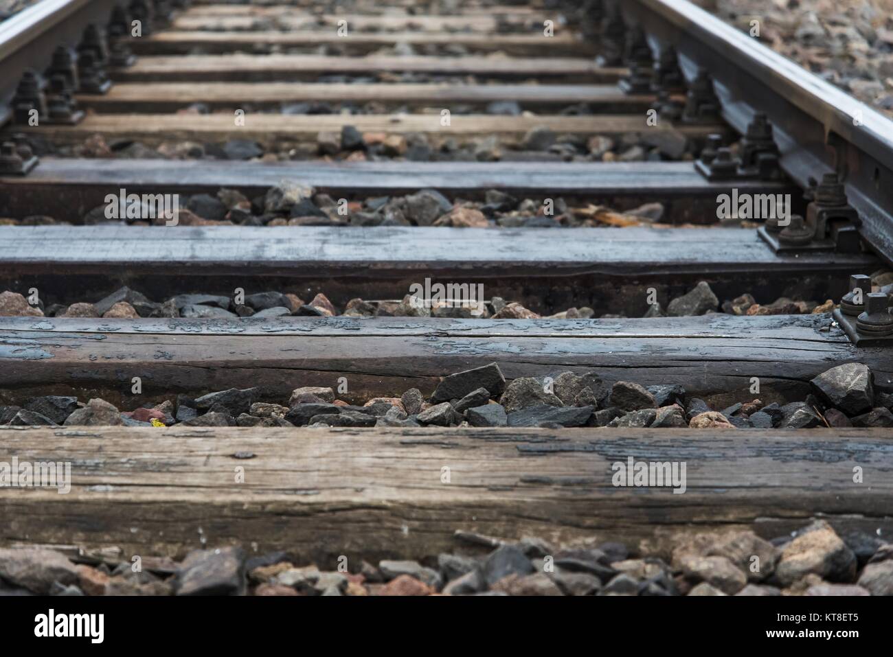Detail of railway tracks with girder and gravel. Shallow DOF Stock Photo