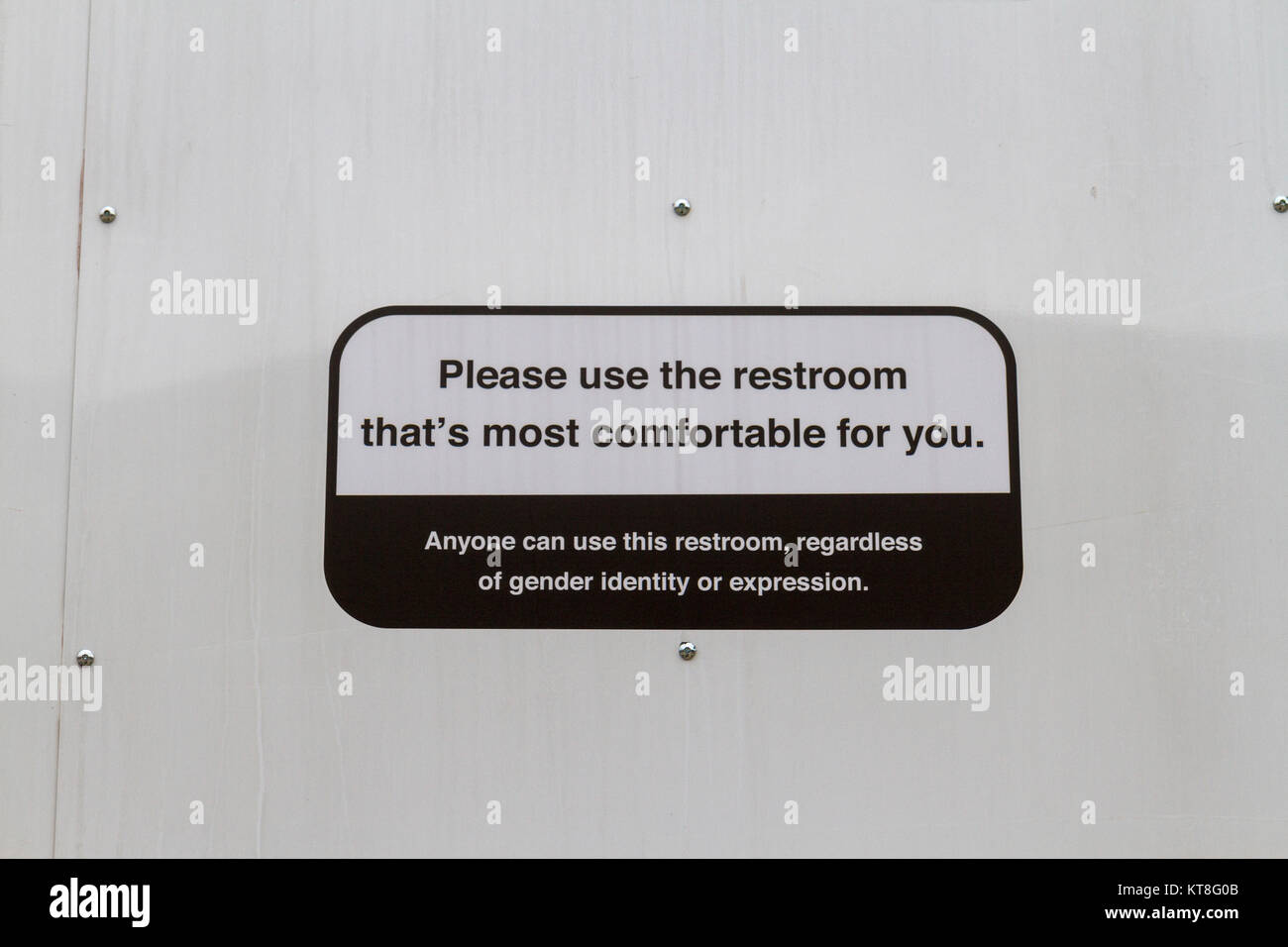 'Please use the restroom that's most comfortable for you': Sign on public restroom in Philadelphia, Pennsylvania, United States. Stock Photo