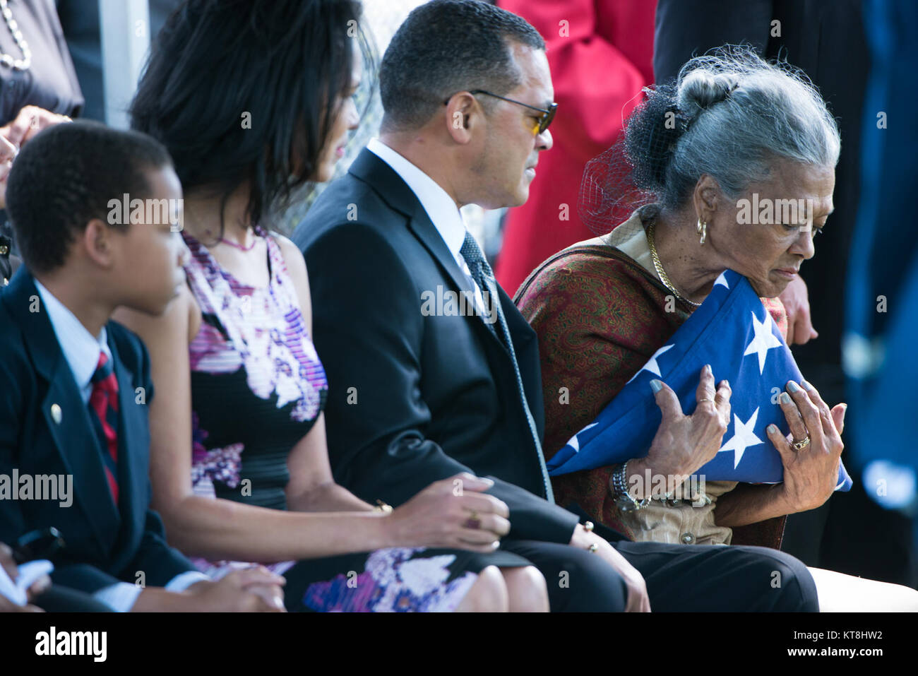 Nola Whitfield reacts after receiving the American flag off her husband