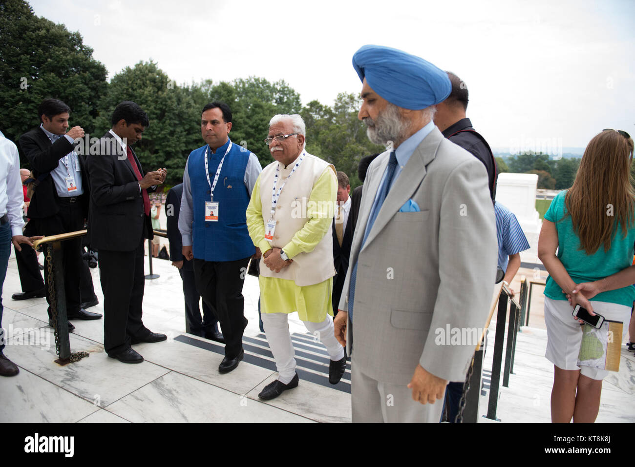 Chief Minister of Haryana, India Manohar Lal Khattar, along with others in the official party and other visitors, walk toward the Memorial Display Room after watching a Changing of the Guard ceremony at the Tomb of the Unknown Soldier in Arlington National Cemetery, Aug. 18, 2015, in Arlington, Va., immediately following a wreath-laying at the Space Shuttle Columbia Memorial. Kalpana Chawla, one of seven crew members killed during the Columbia disaster. She was born in Karnal, India, and was posthumously awarded the Congressional Space Medal of Honor, the NASA Space Flight Medal, and the NASA  Stock Photo