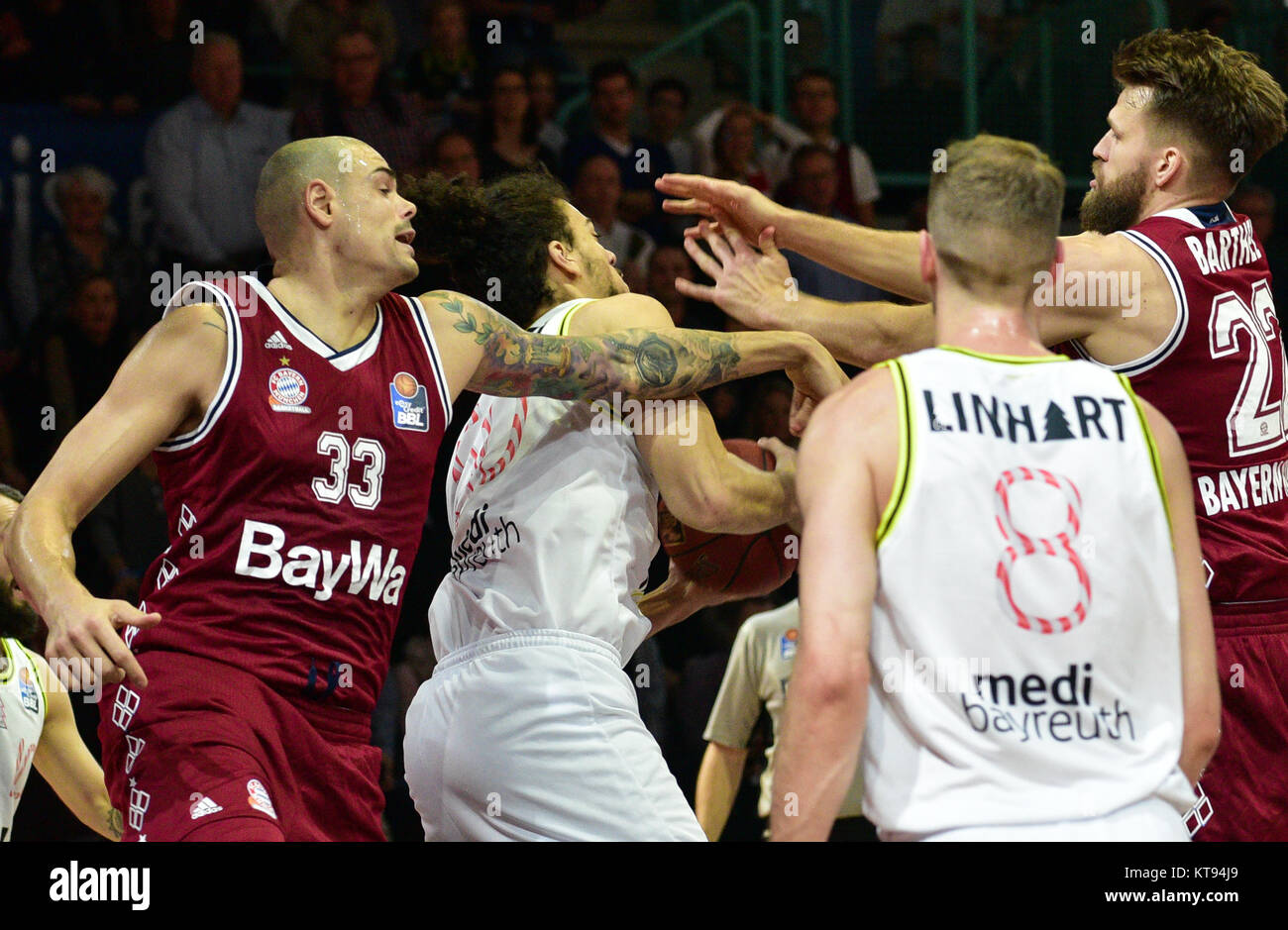 Bayreuth, Germany. 22nd Dec, 2017. Bayern's Maik Zirbes (l) and Danilo Barthel (r) vie for the ball with Bayreuth's Assem Marei (2.f.l.) and Nate Linhart (2.f.r.) during the German Bundesliga basketball game between medi Bayreuth and FC Bayern Munich at the Oberfrankenhalle in Bayreuth, Germany, 22 December 2017. Credit: Nicolas Armer/dpa/Alamy Live News Stock Photo
