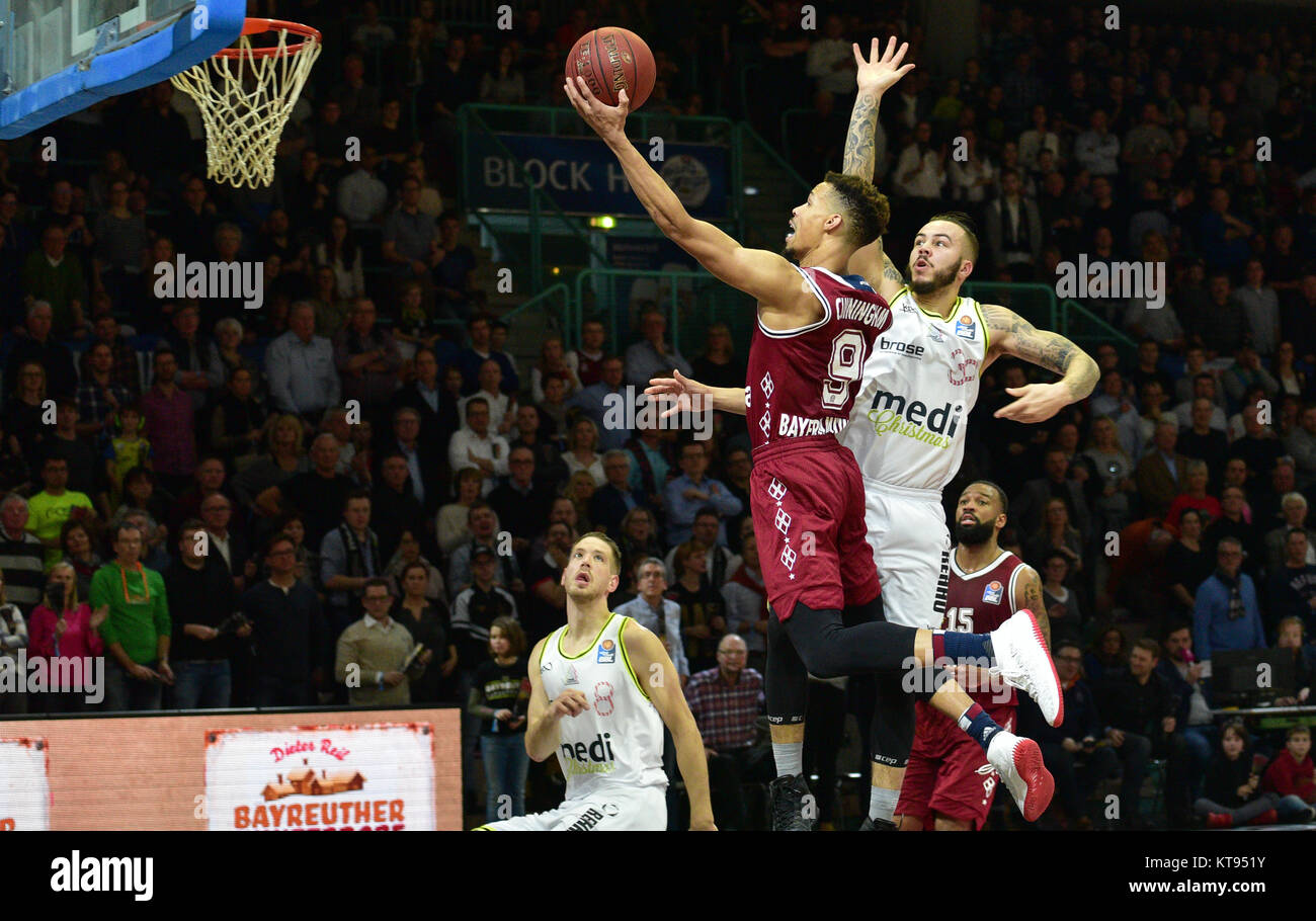 Bayern's Jared Cunningham (2.f.l.) and Reggie Redding (r) vie for the ball with Bayreuth's Bastian Doreth (2.f.r.) and Nate Linhart (l) during the German Bundesliga basketball game between medi Bayreuth and FC Bayern Munich at the Oberfrankenhalle in Bayreuth, Germany, 22 December 2017. Photo: Nicolas Armer/dpa Stock Photo