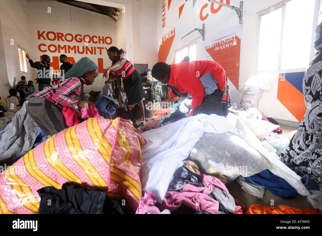 Nairobi, Kenya. 22nd Dec, 2017. Women seen sorting out hundreds of clothes. Some of Kororgocho slum dwellers in Nairobi, Kenya sift through assorted clothing donated through an initiative dubbed ''˜Mng'aro Mtaani' ahead of Christmas celebration where people across the city give out clothing they don't use to the less fortunate. Initiative's founder Mr. Sam Omoll ''“ Torez who grew up in the slum said over 60,000 people living in Korogocho lack basic needs among them shelter, clothing, clean water and food. Majority survive on less than 1 USD a day, experience high crime rate, lack Stock Photo
