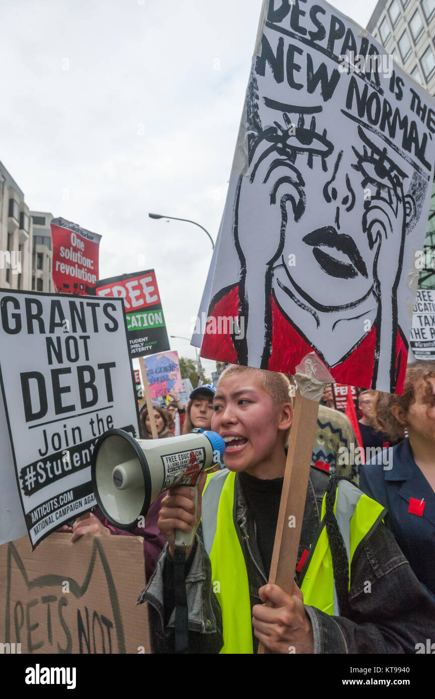 The NCAFC student march stopped to protest outside the Dept for Business, Innovation & Skills. A student with a megaphone carries a placard 'Despair is the New Normal'. Stock Photo