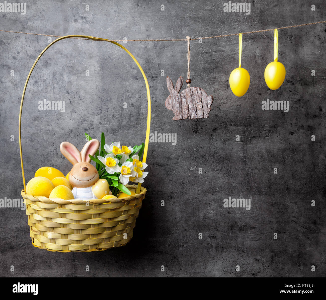 Easter eggs and bunnies on hanging on rustic background Stock Photo - Alamy