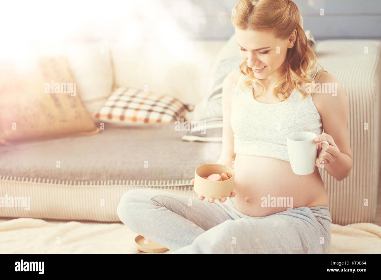 Sweet Life Positive Young Pregnant Woman Sitting On The Floor And