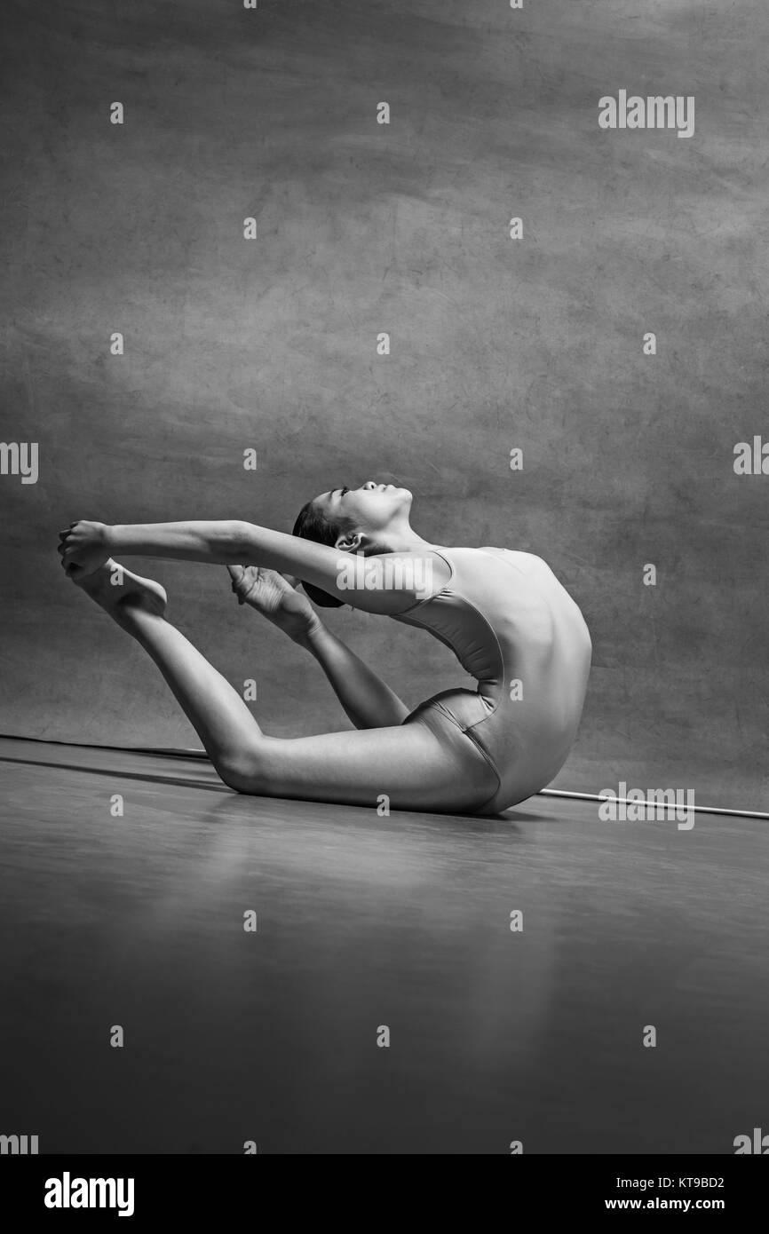 The female ballet dancer posing over gray background Stock Photo