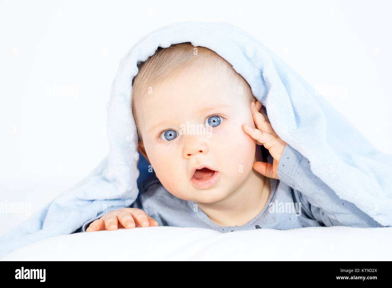 beautiful baby boy lying in bed on white background Stock Photo ...