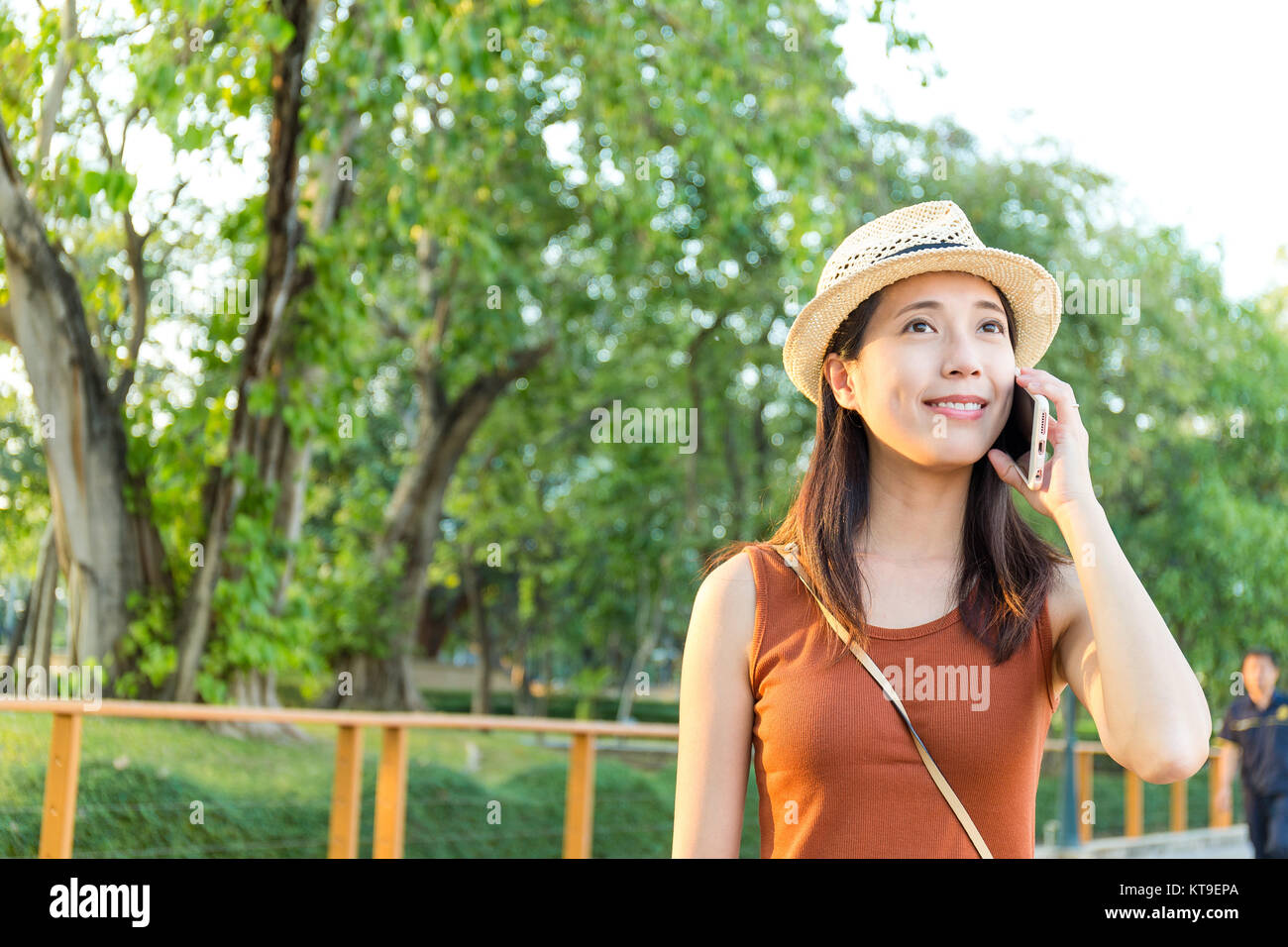 Woman talk to cellphone at green park Stock Photo - Alamy