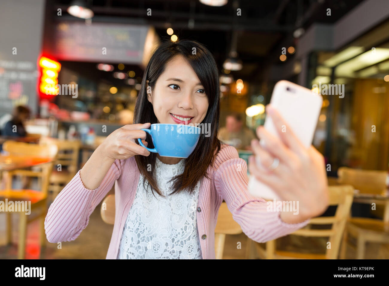 Woman taking selfie in coffee shop Stock Photo - Alamy