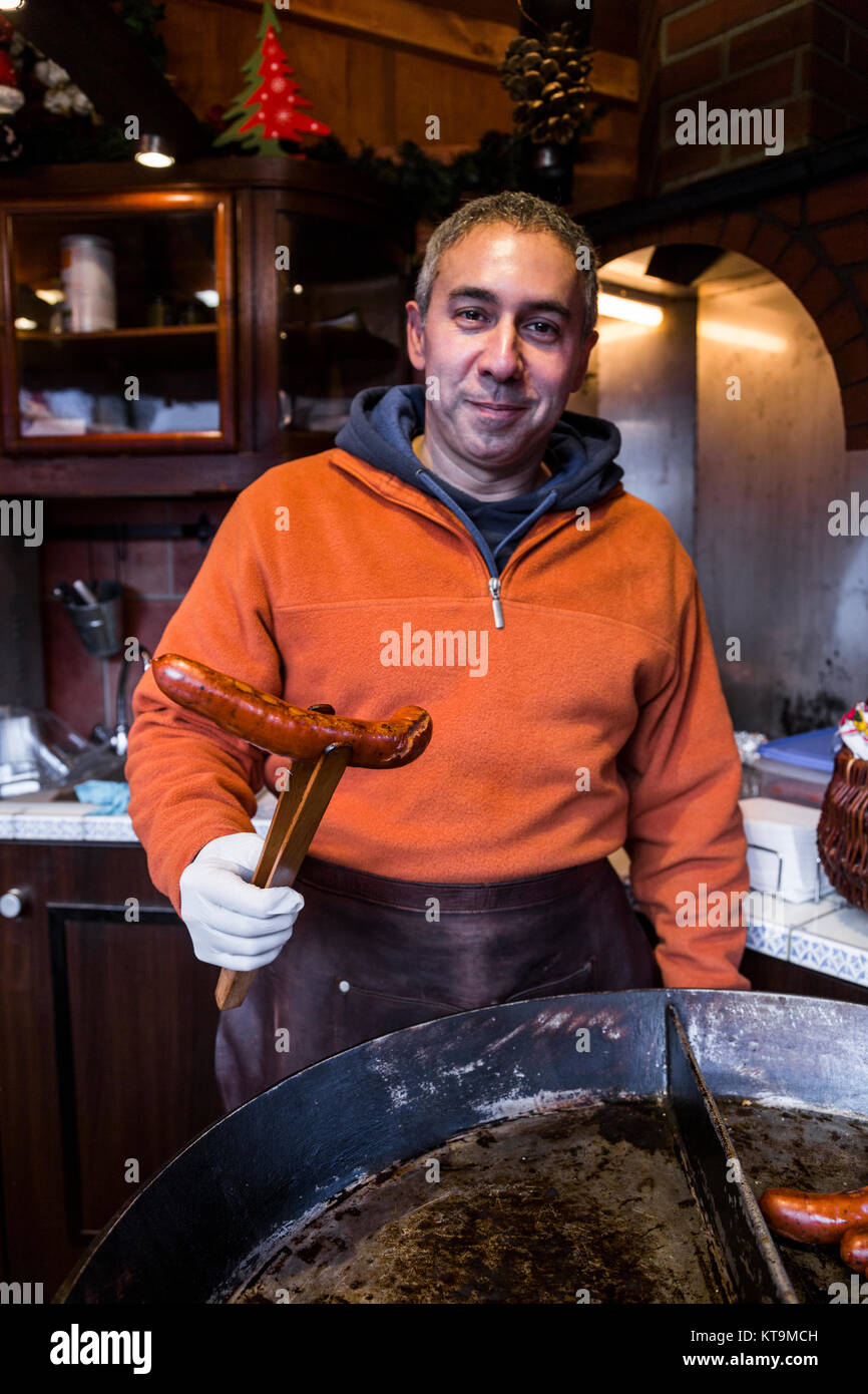 Male seller chef baker in white gloves holds national traditional