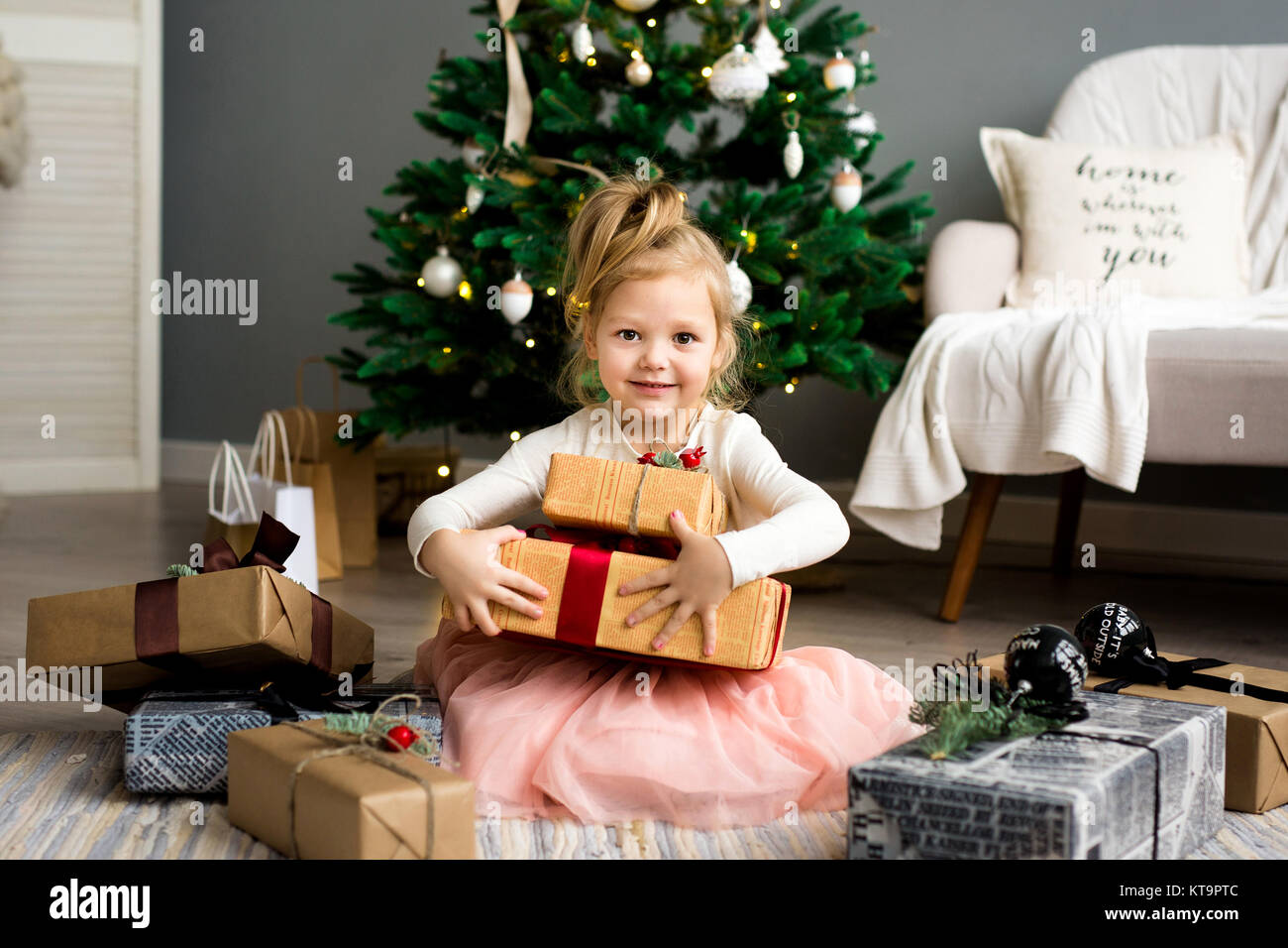 Happy cute little smiling girl with christmas gift box. Merry Christmas ...
