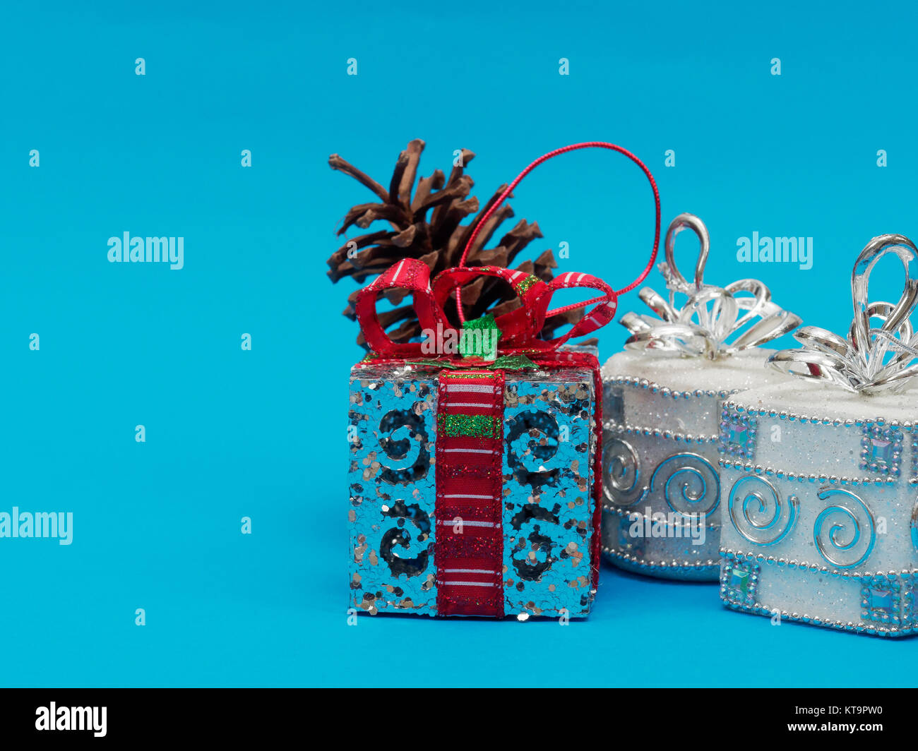 White shiny silver gift box with red ribbon and bow with silver white ...