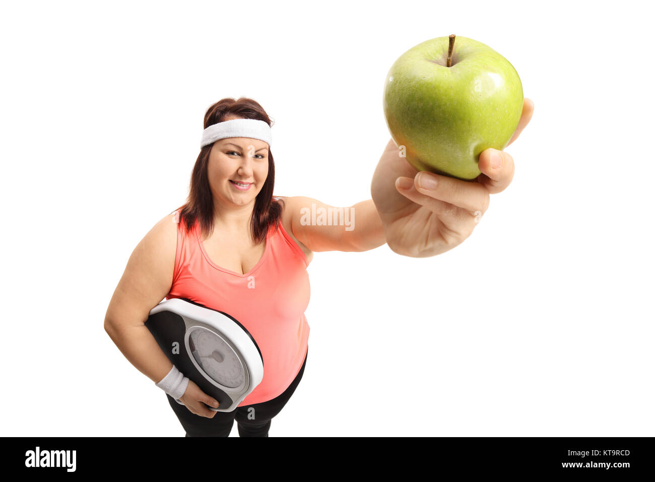 Overweight woman with a weight scale and an apple isolated on white