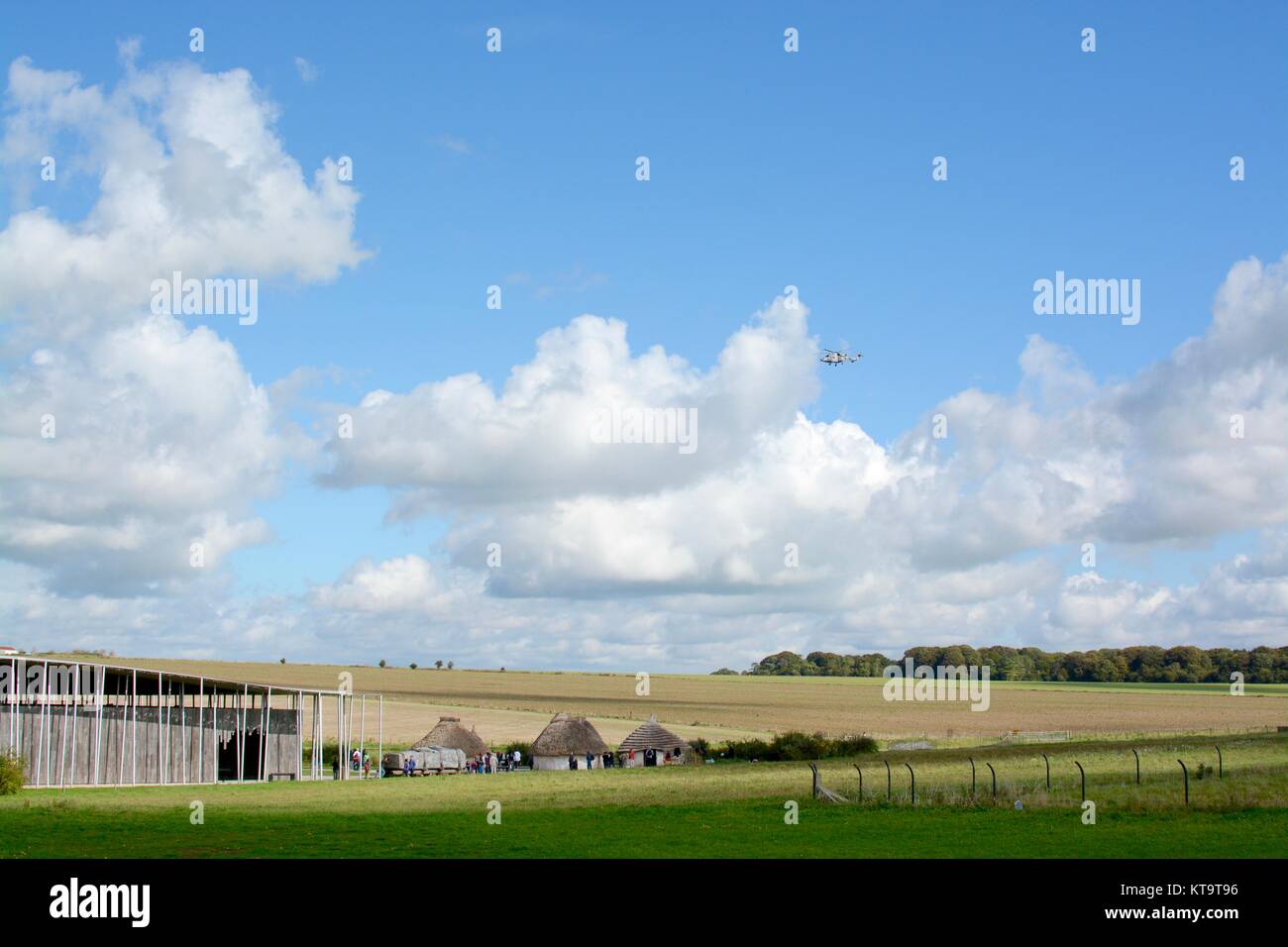Military helicopter flying over the entrance to Stonehenge, near Amesbury, Wiltshire, England, UK Stock Photo