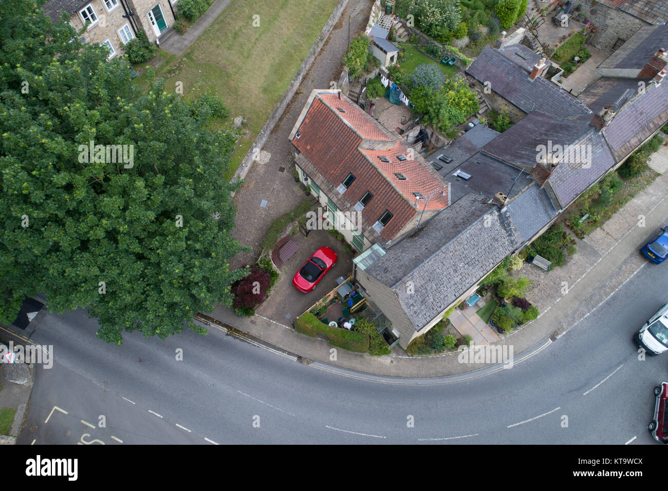 Overview of shiny red car standing in driveway of historic home, of Richmond, Yorkshire, England Stock Photo