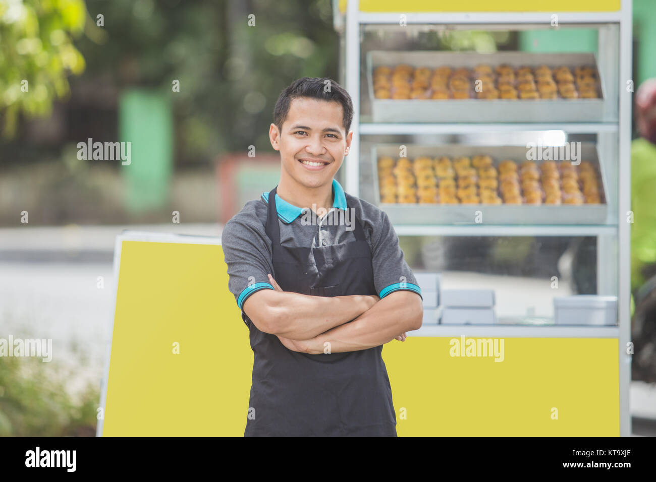 small business owner standing proudly in front of his food stall Stock ...