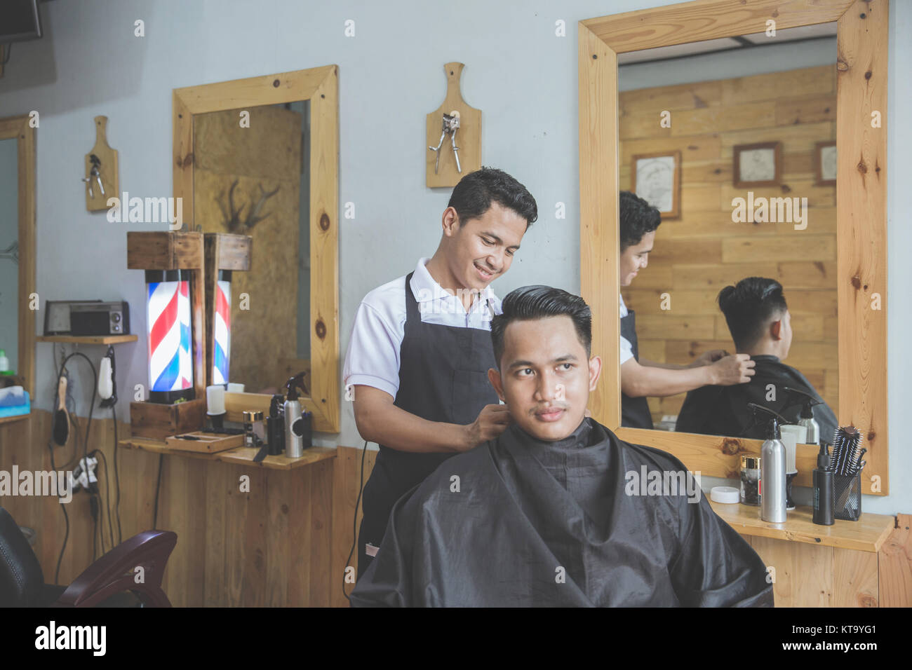 happy barber getting ready to cut his client hair at barbershop Stock ...