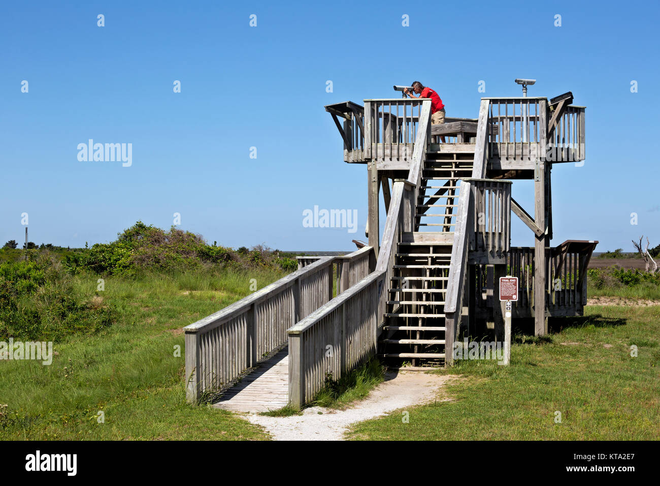 NC01158-00...NORTH CAROLINA - Trail at the Pea Island National Wildlife Refuge leads to tall viewing platform with viewing scopes overlooking the salt Stock Photo