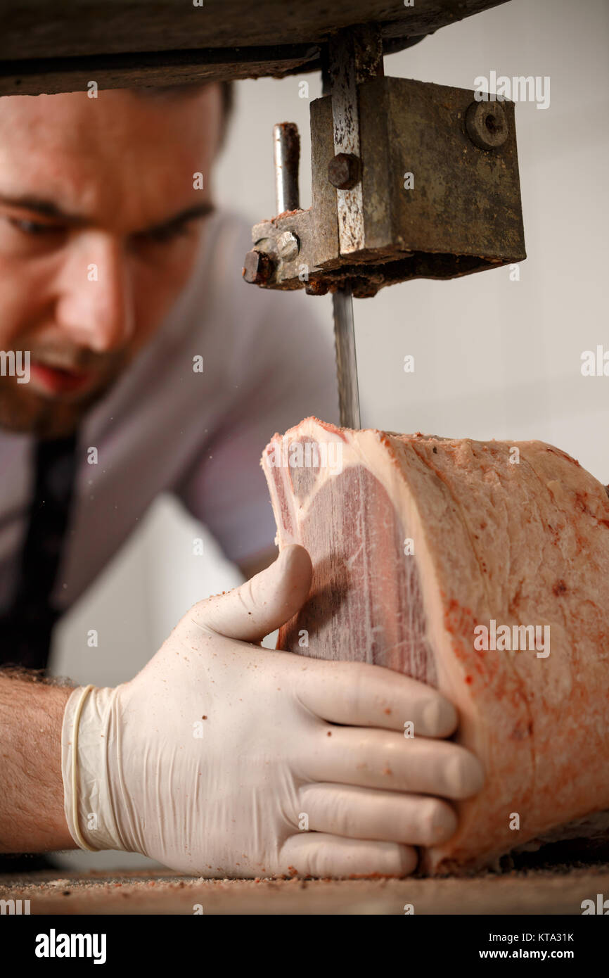 Butcher is slicing meat Stock Photo