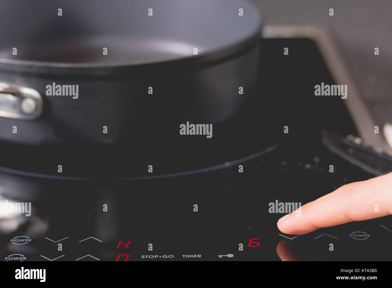 cook is switching on the induction cooktops Stock Photo Alamy
