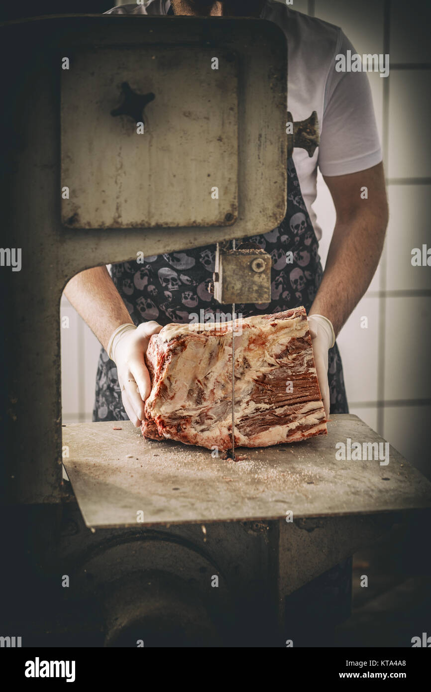 Butcher is cutting meat Stock Photo
