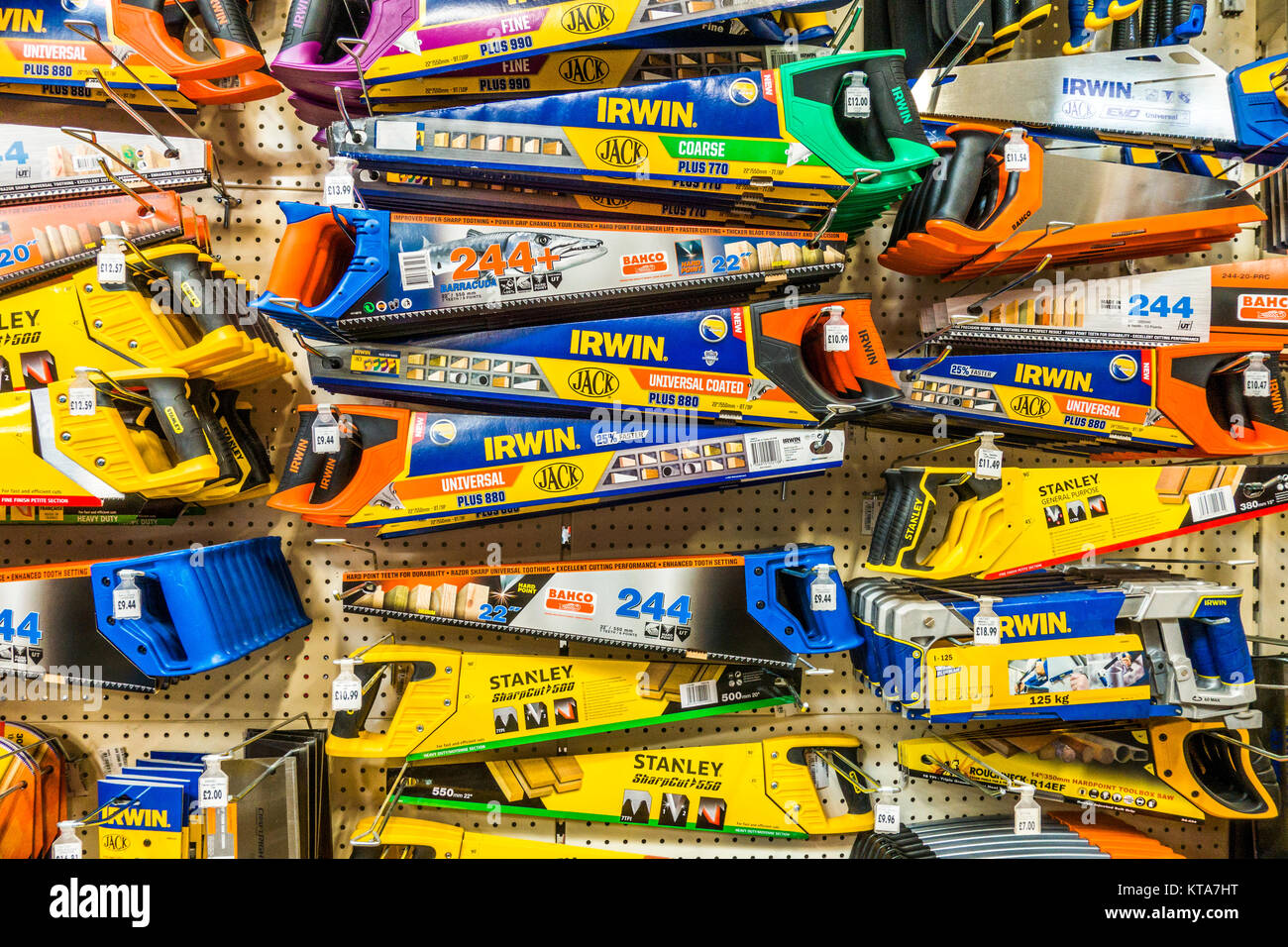 An extensive and colourful selection of Stanley and Irwin hand saws of varying size, on display in a Homebase DIY store in England, UK. Stock Photo