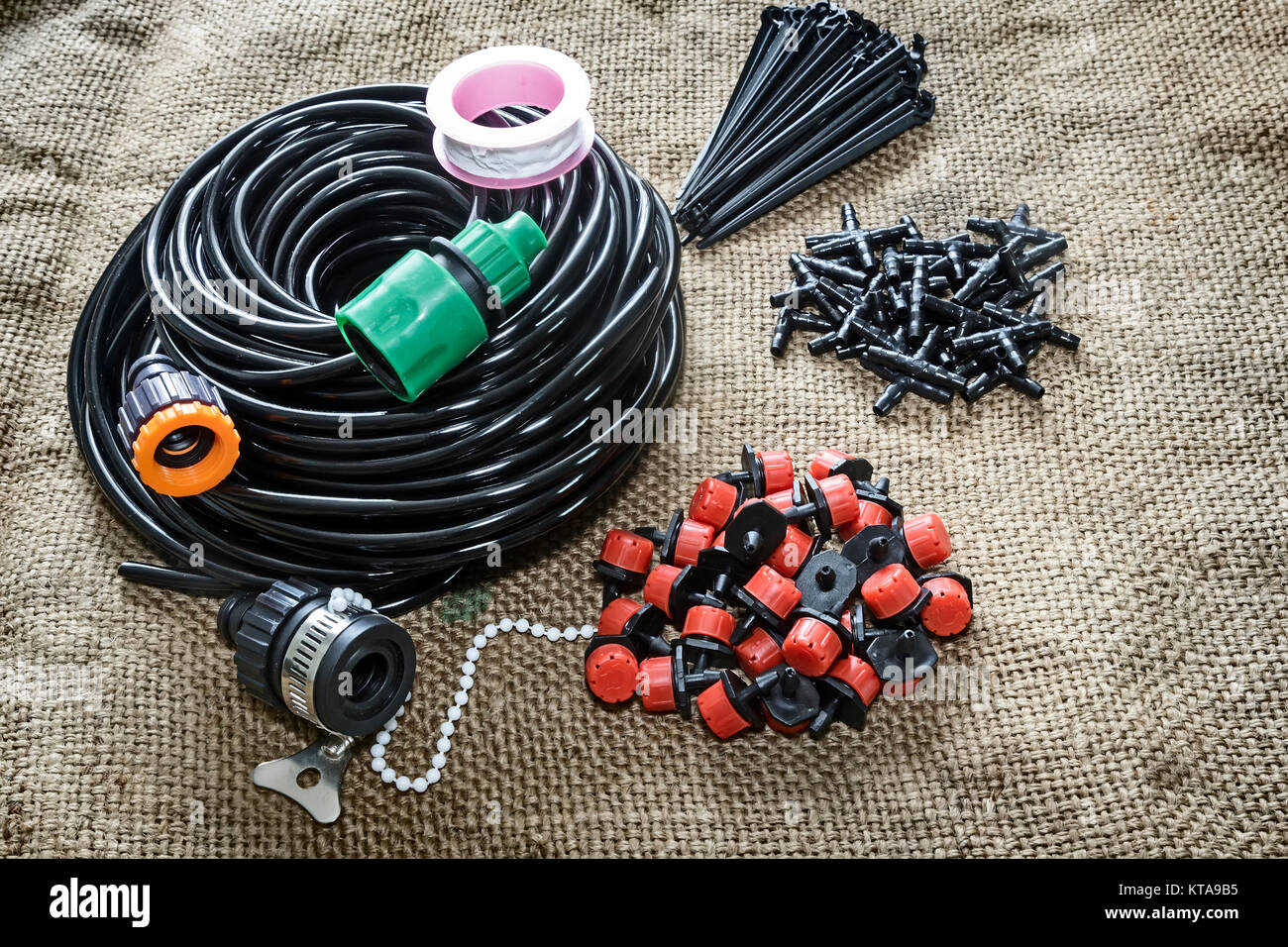 A set of tools for drip irrigation of plants and garden: hose, sprinklers,  joints, hose holders Stock Photo - Alamy