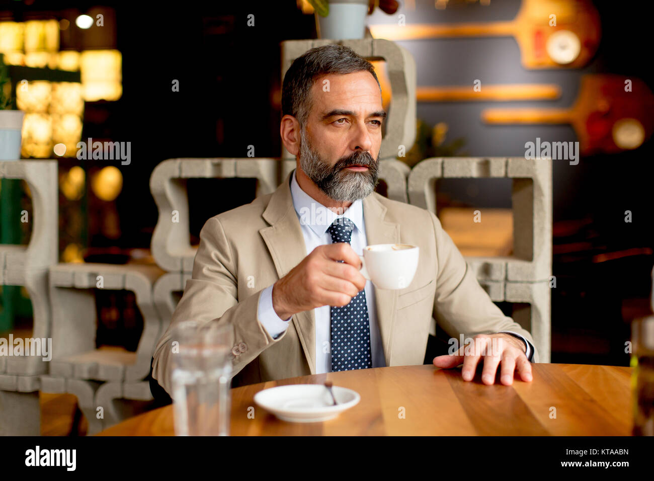 Handsome mature man drinking red wine during lunch Stock Photo Alamy