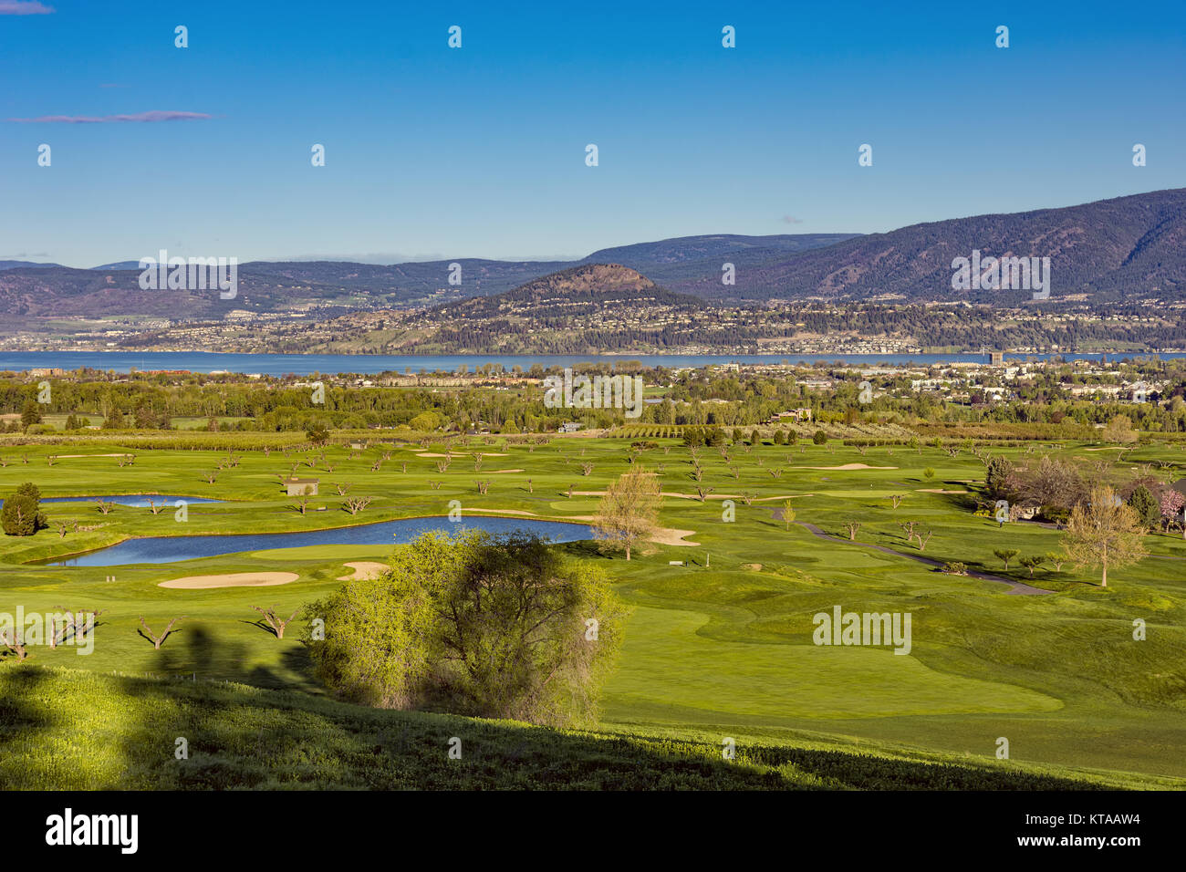 A golf course in the Okanagan Valley with the Kelowna British Columbia Canada skyline and Okanagan Lake in the background Stock Photo