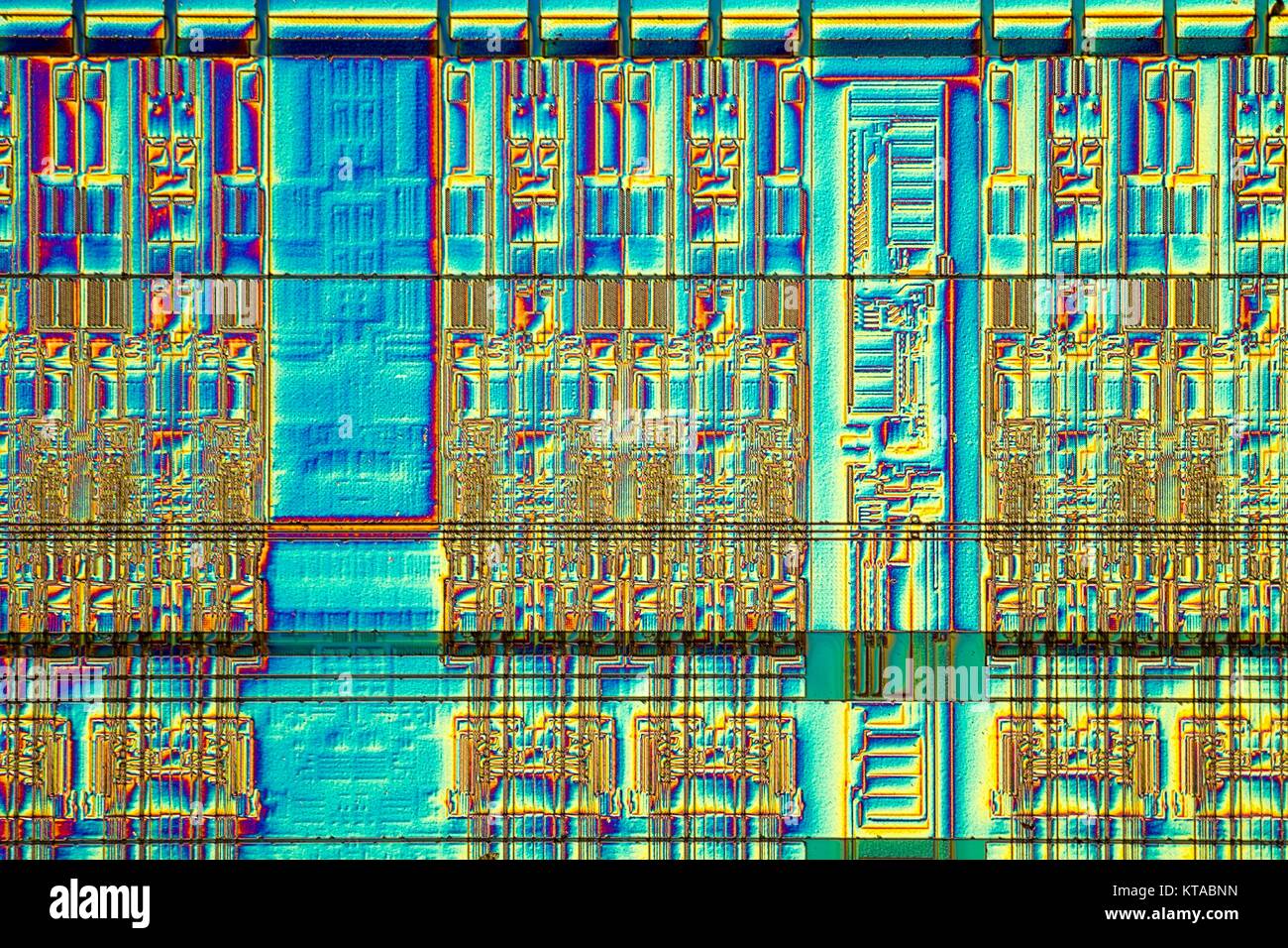 Light micrograph of a detail of a RAM computer memory chip. RAM is a type of computer memory that can be accessed randomly; that is, any byte of memory can be accessed without touching the preceding bytes.This is the most common type of memory found in personal computers and different other electronic devices like cellular phones, usb sticks and printers. Objcet size of this section approx. 1.2 mm across. Stock Photo
