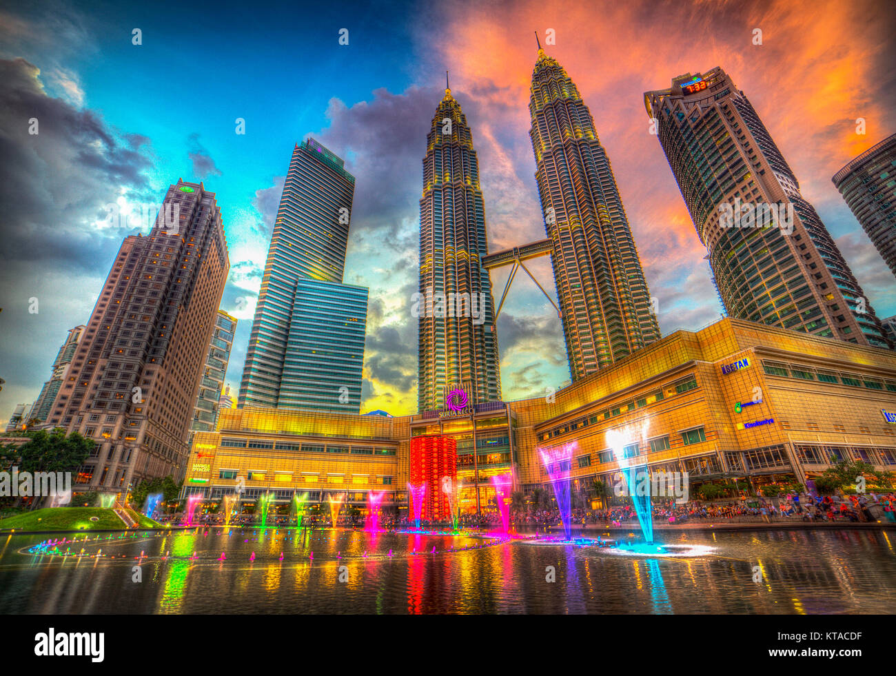 Colourful light and water shows entertain shoppers and visitors nightly by the pool at the Suria KLCC shopping mall, Kuala Lumpur, Malaysia. Stock Photo