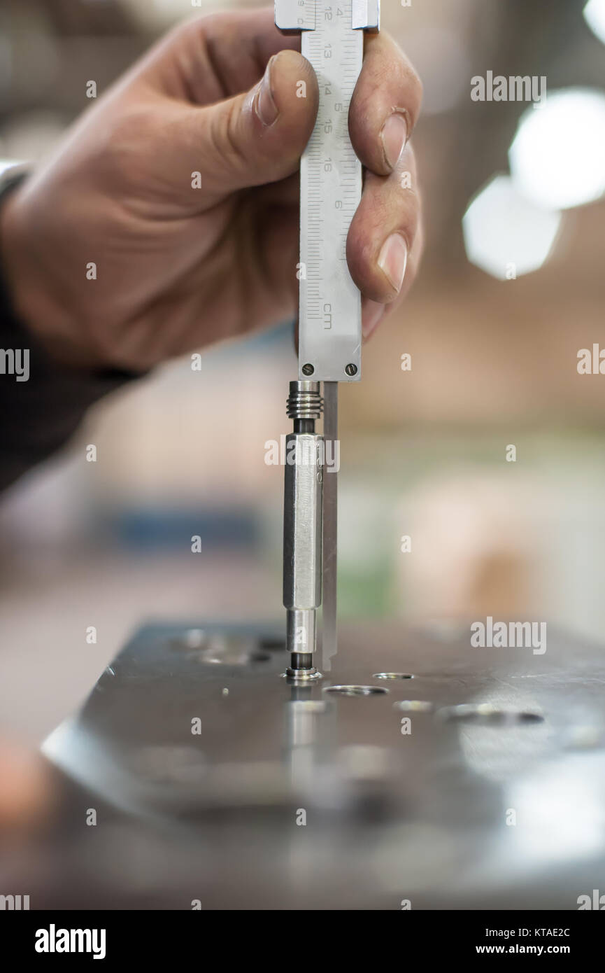 Repairer using accurate ruler for measuring in workshop. Close up Stock ...
